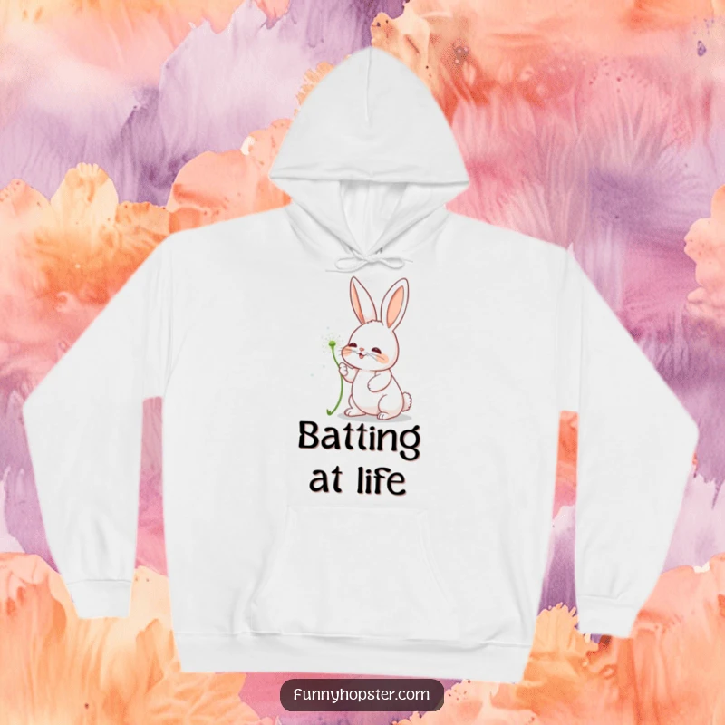 Funny hoodie depicting a charming rabbit character playfully interacting with a floating dandelion seed.