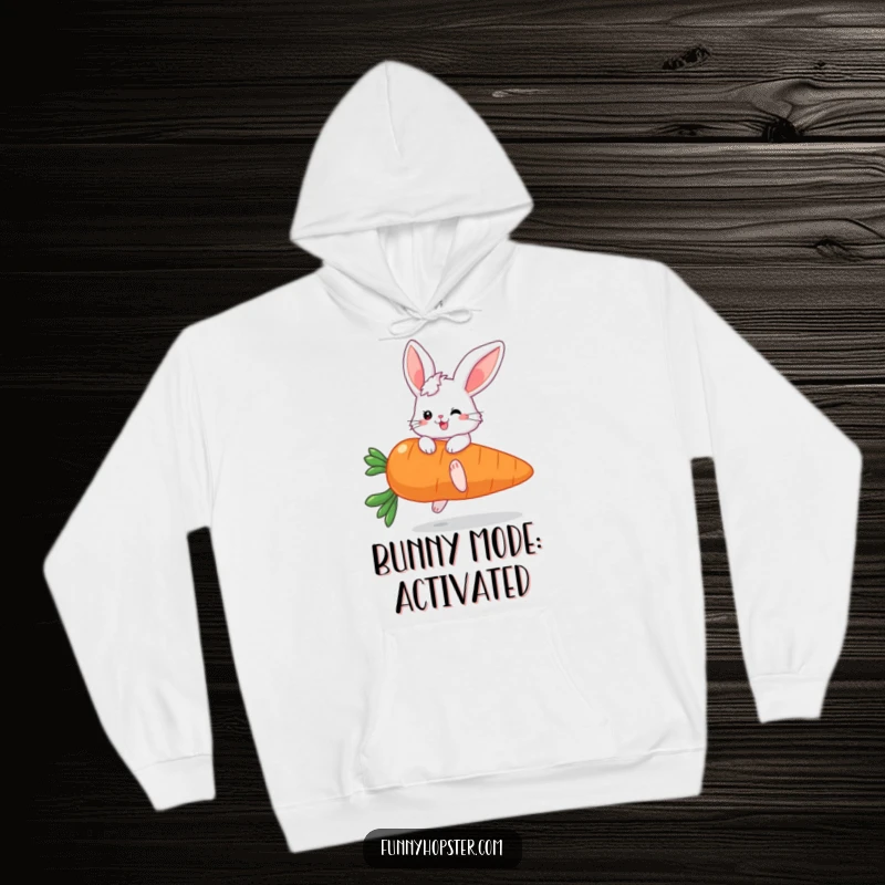 Funny hoodie showcasing a fluffy bunny character with large ears enthusiastically bouncing on a huge carrot, radiating happiness.