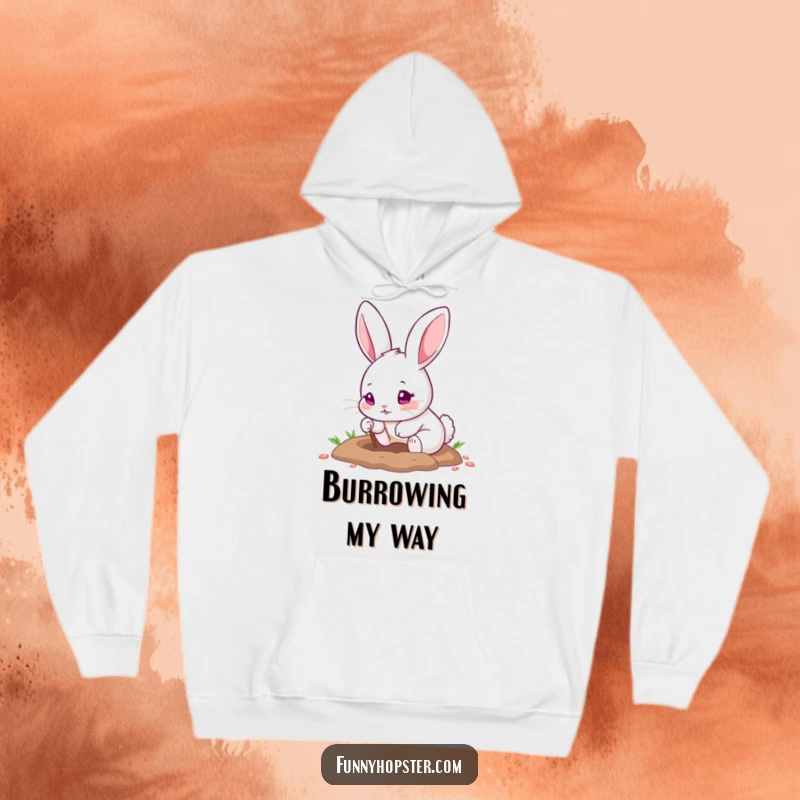 Funny hoodie showcasing a cute rabbit with pink eyes, enthusiastically digging a hole using its tiny paws, full of effort.